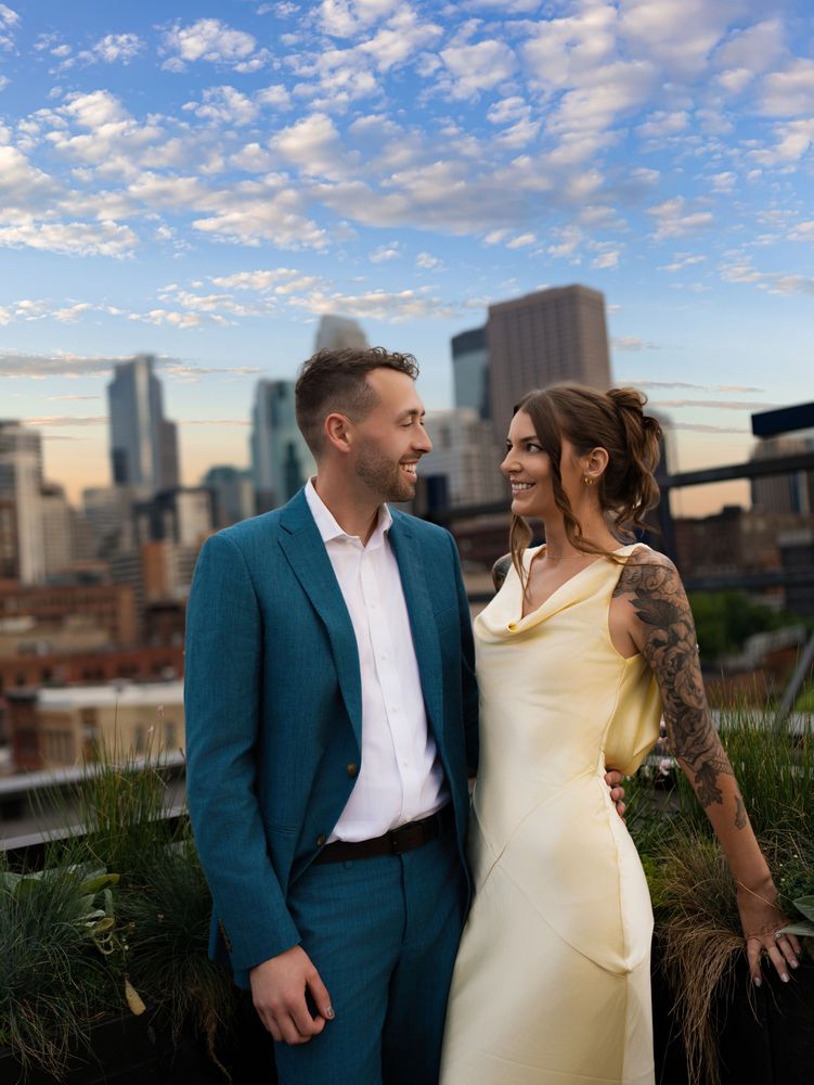 Couple at golden hour with the Minneapolis skyline behind