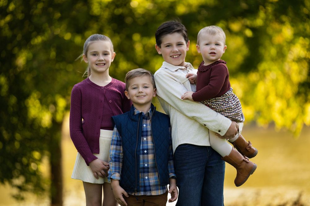 Siblings together in golden autumn light