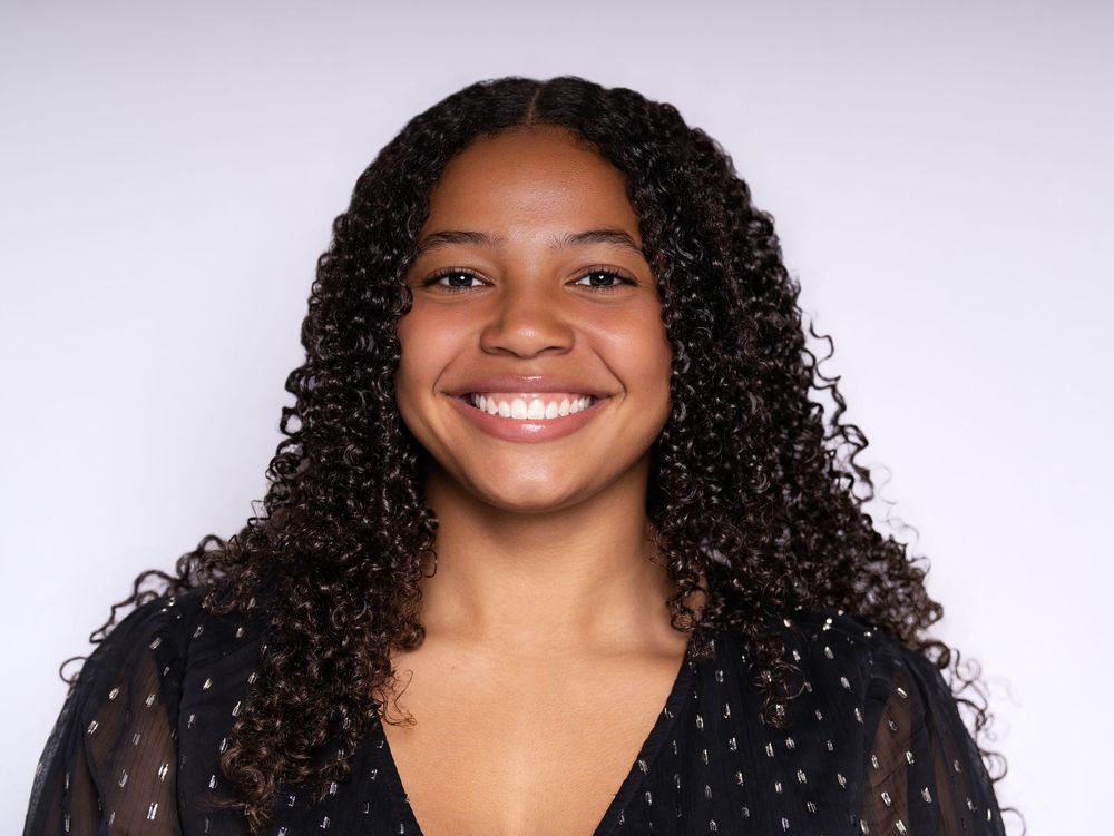 Smiling professional headshot on a light gray backdrop