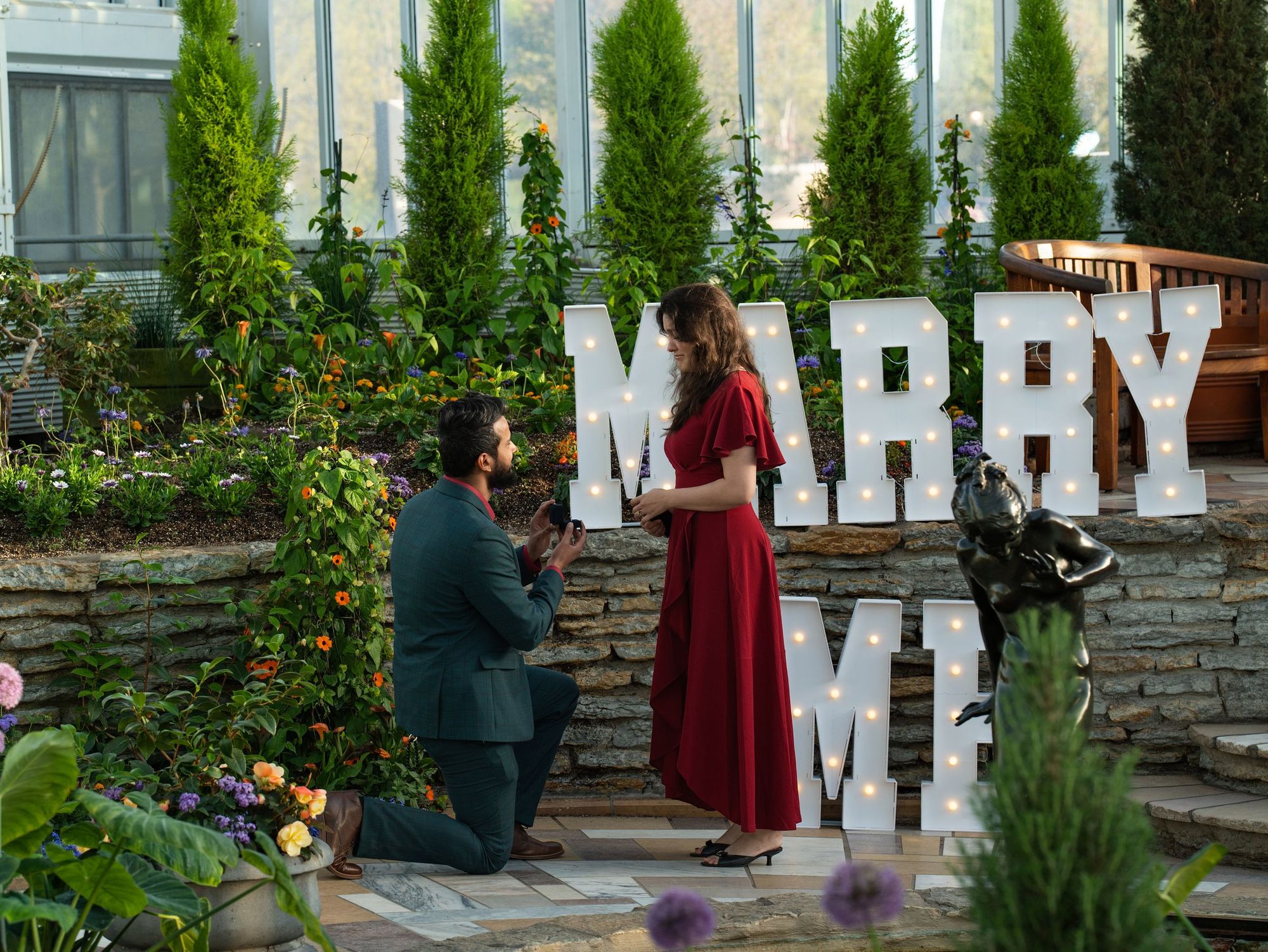 Garden proposal with lit MARRY ME letters