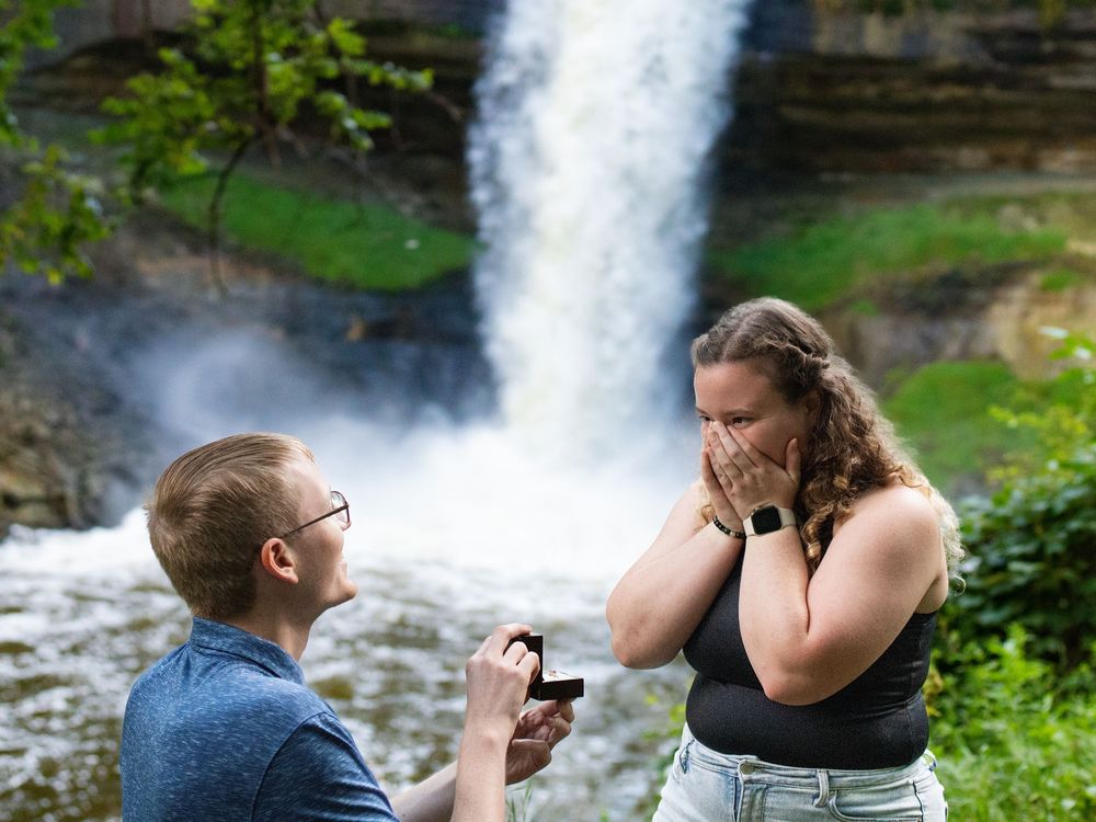 Proposal in front of a waterfall
